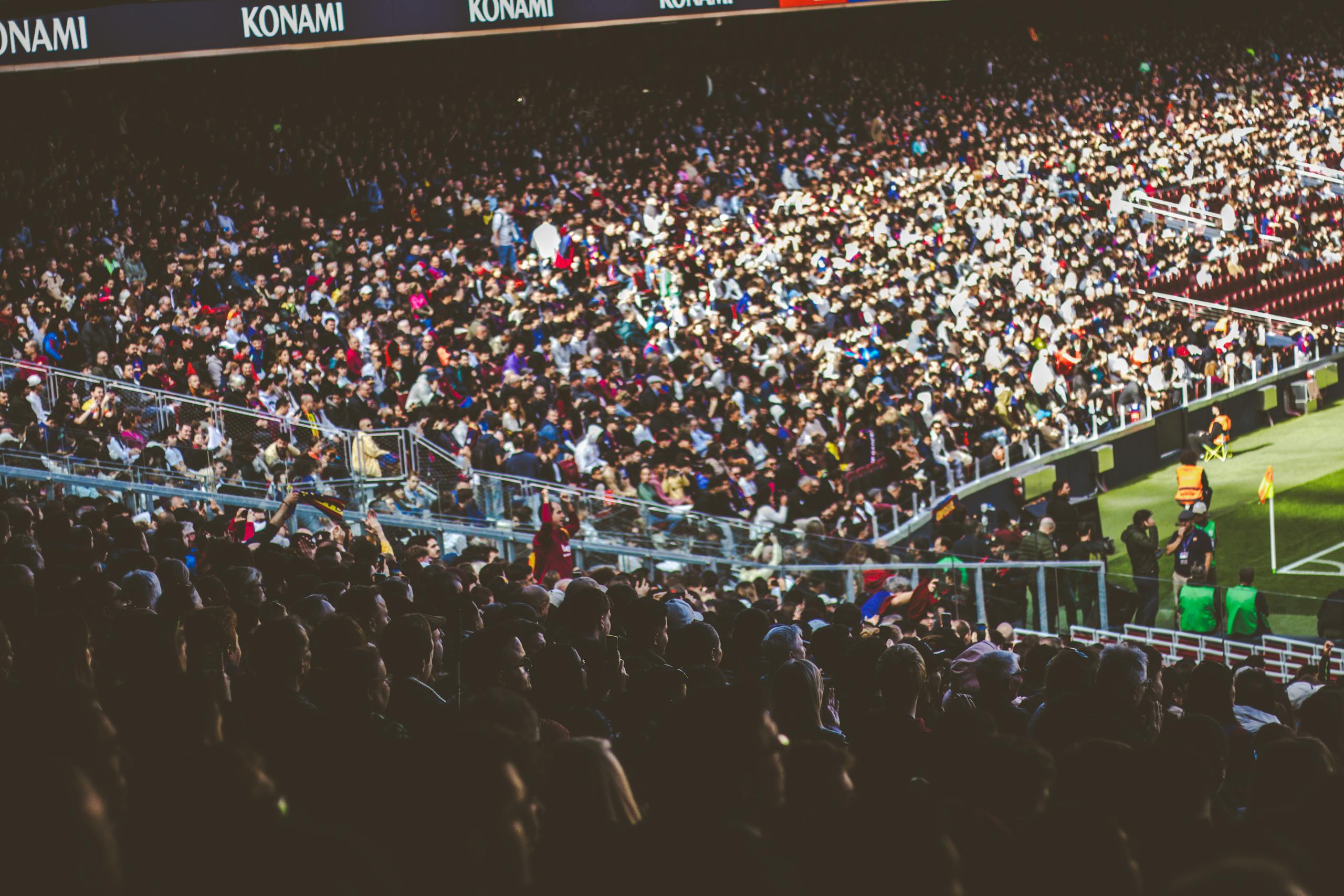A crowded soccer stadium packed with enthusiastic fans during a match.