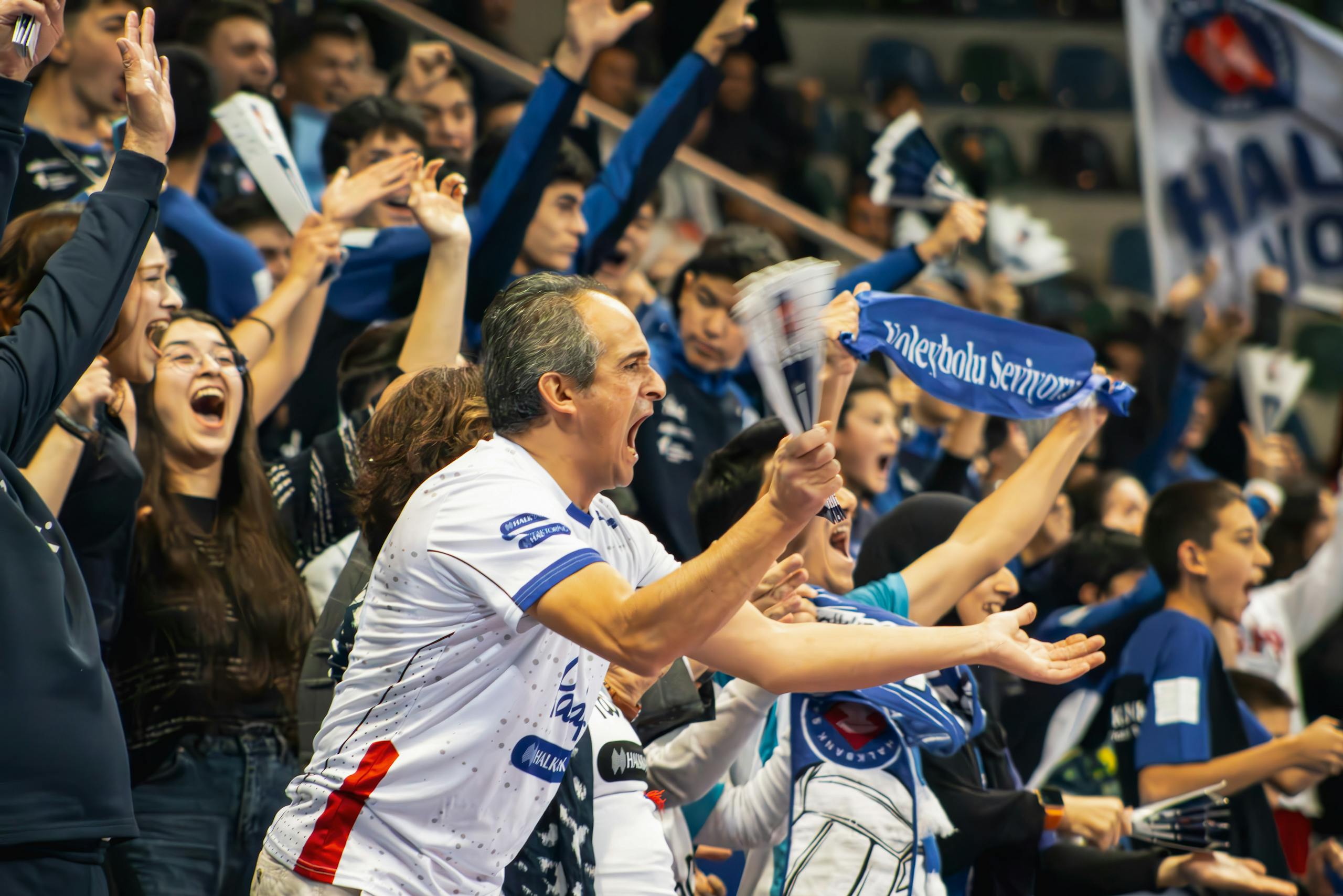 A vibrant crowd cheers enthusiastically at a sports event in Ankara, Türkiye, capturing the energy and excitement.