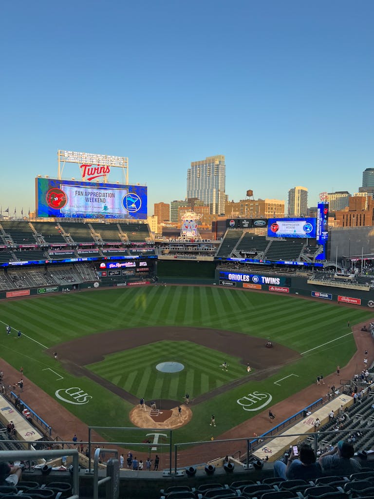 A vibrant evening view of Target Field hosting a baseball game in summer.