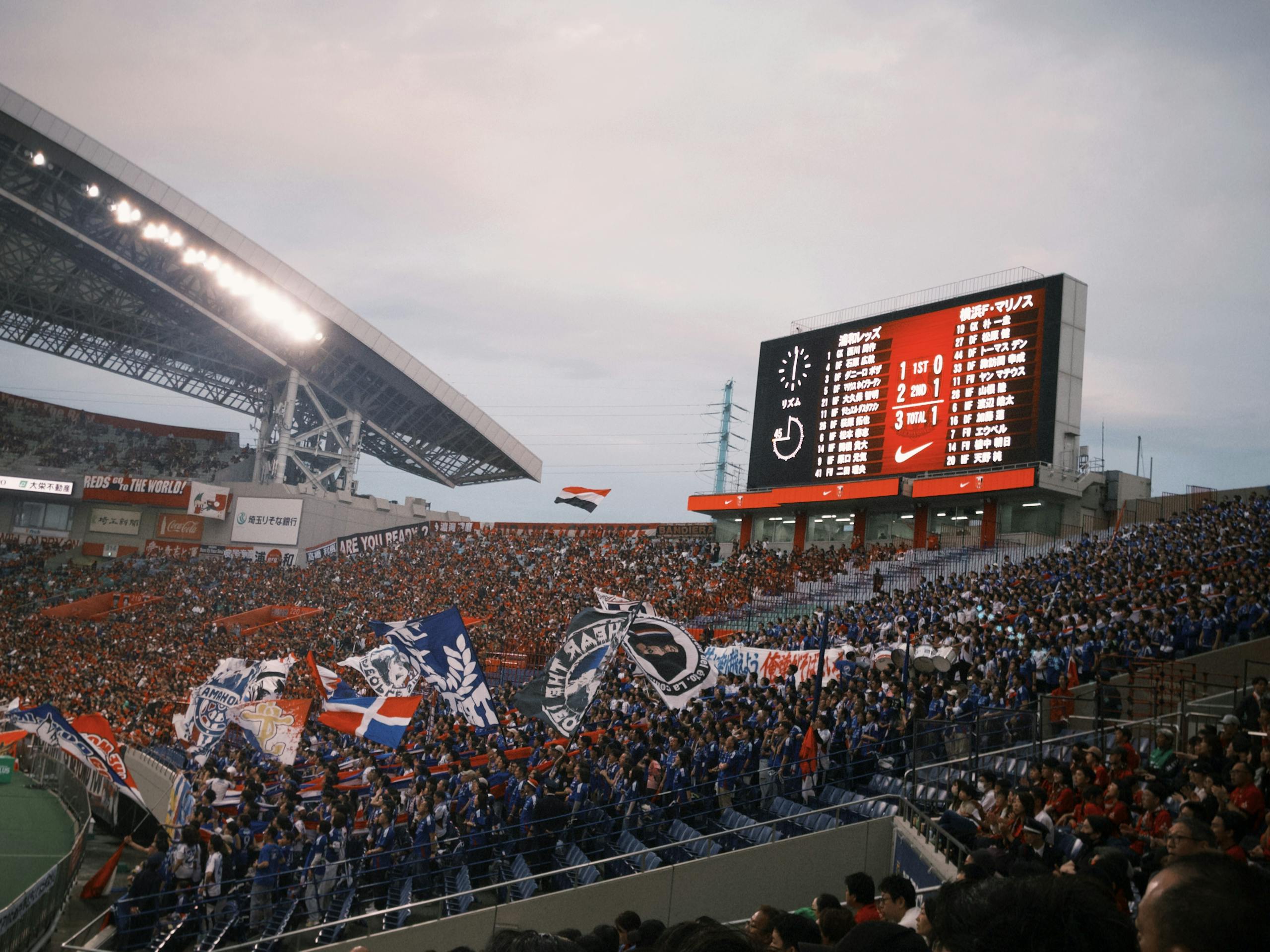 A vibrant soccer match with cheering fans at a packed stadium showcasing team spirit.