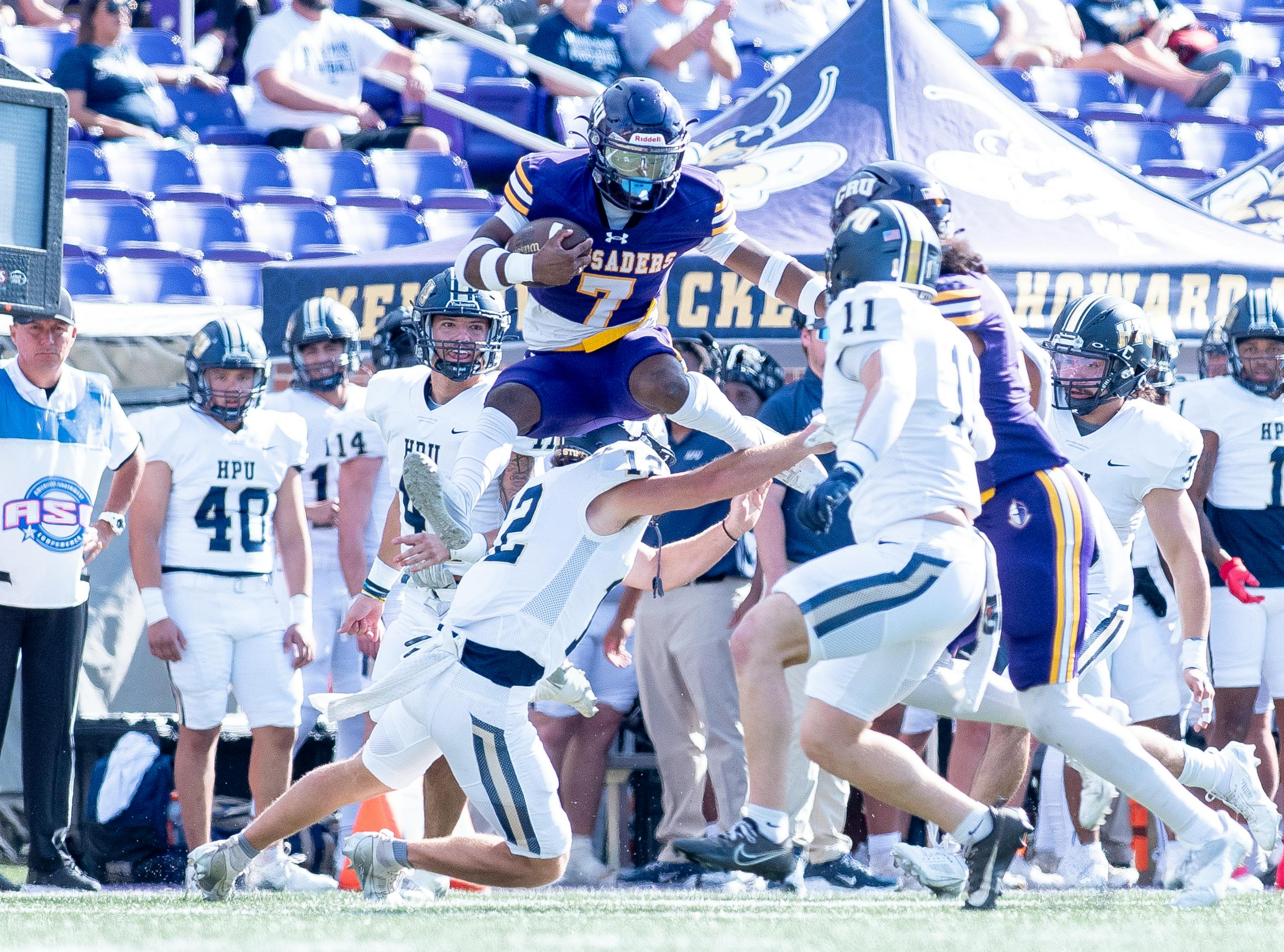 Exciting moment in a college football game with players in mid-action.