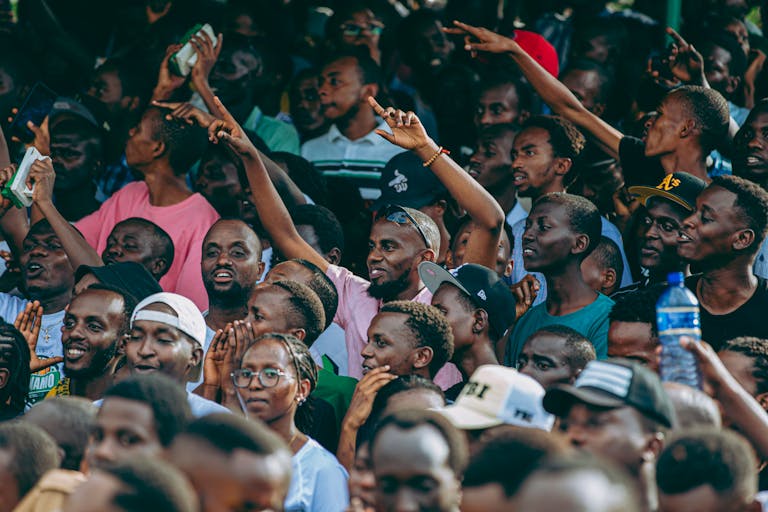 A vibrant crowd of diverse people enjoying an outdoor event during the day.