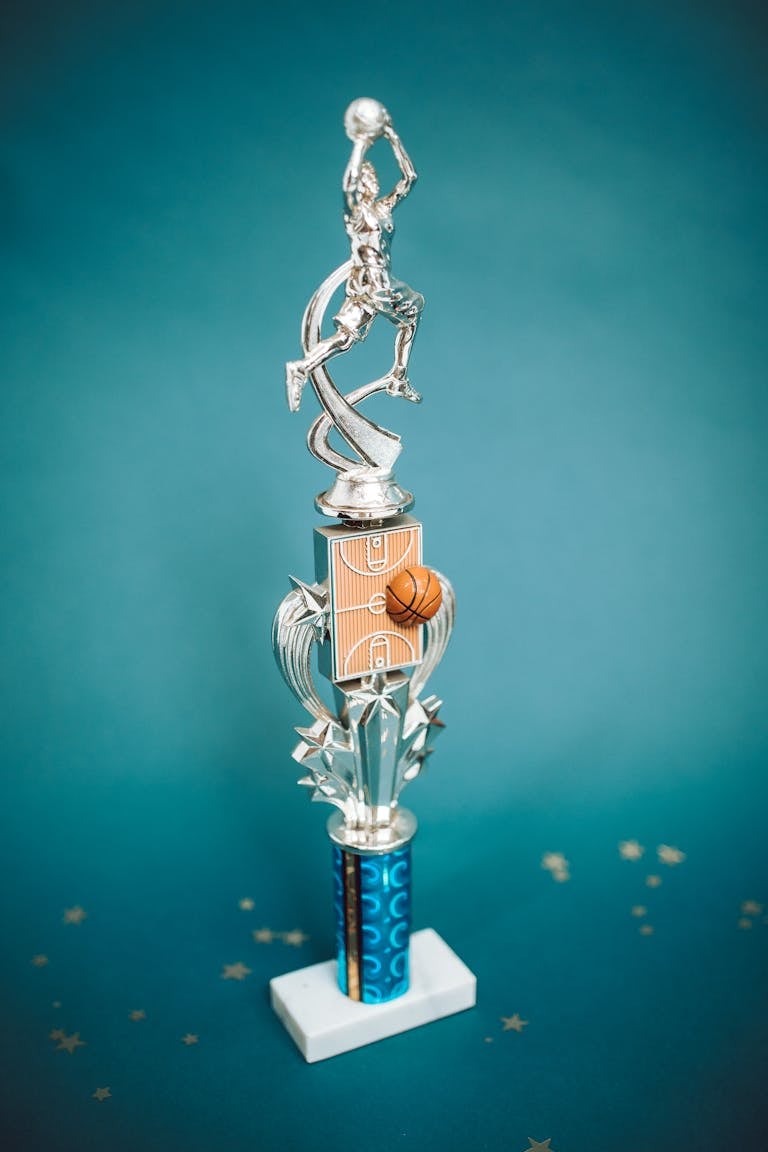 Silver basketball trophy with a vivid blue background symbolizing victory and achievement.