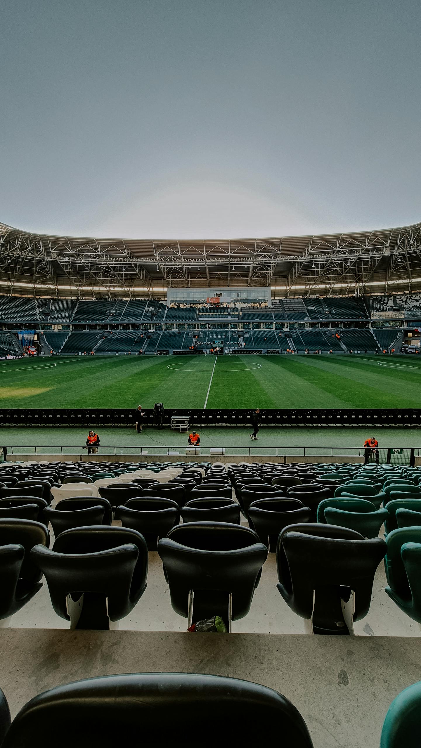 Wide-angle view of an empty football stadium, perfect for sports-themed projects.