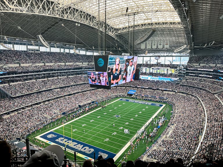 A packed AT&T Stadium in Arlington, Texas, showcasing a thrilling football game with enthusiastic fans.