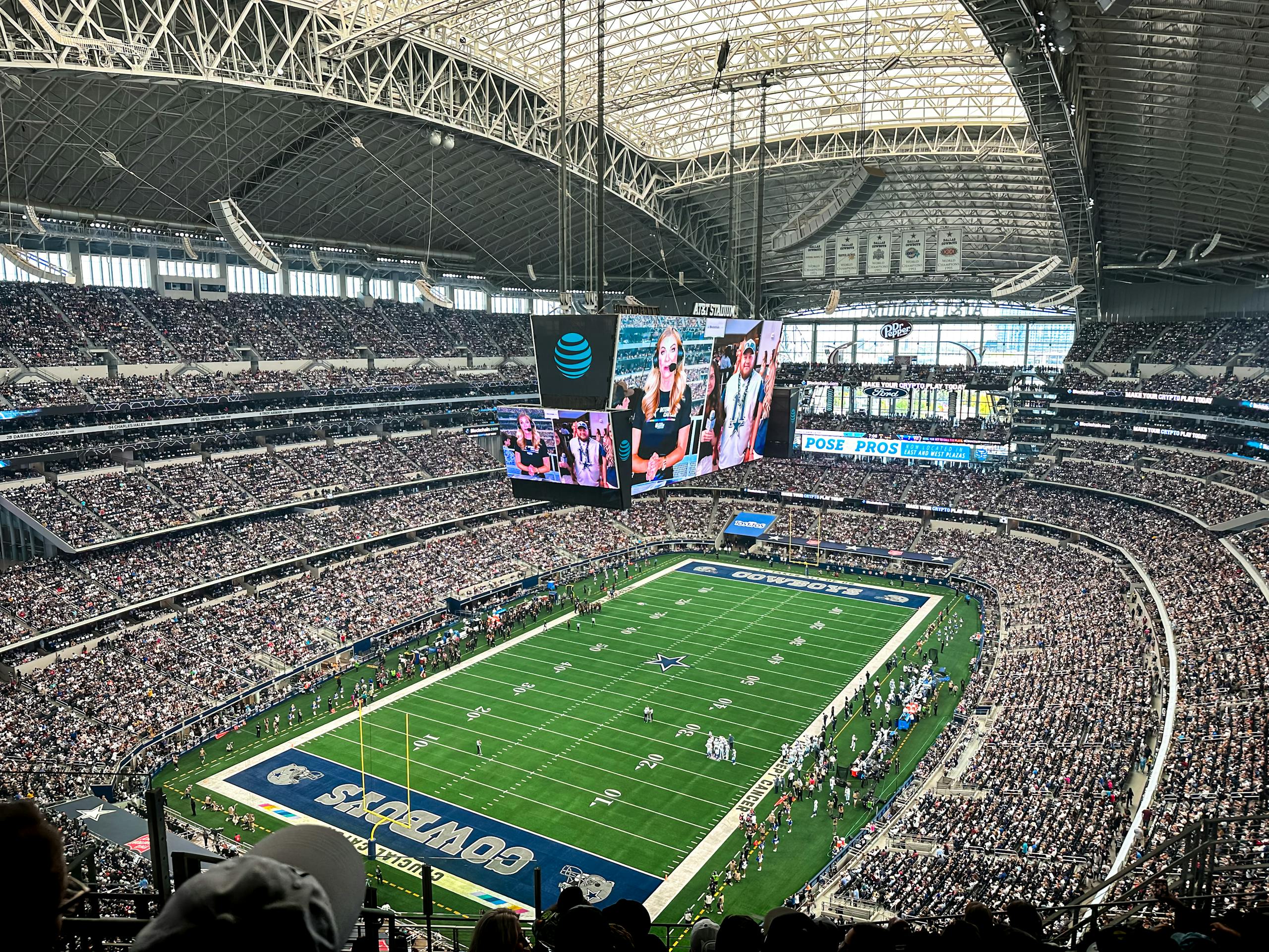 A packed AT&T Stadium in Arlington, Texas, showcasing a thrilling football game with enthusiastic fans.