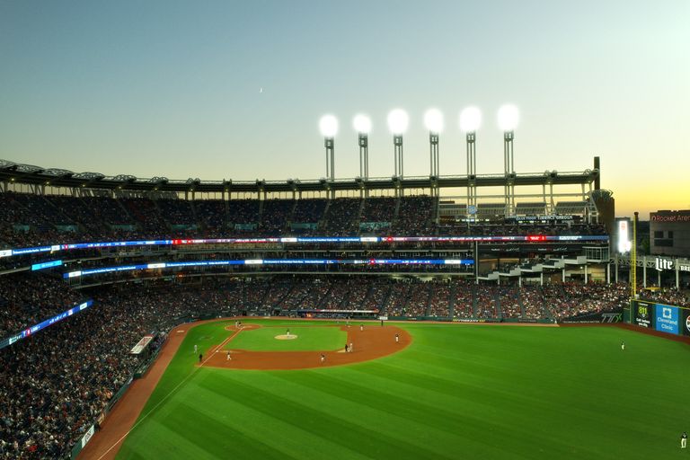 A vibrant twilight baseball game at Cleveland's Progressive Field, capturing the lively atmosphere.