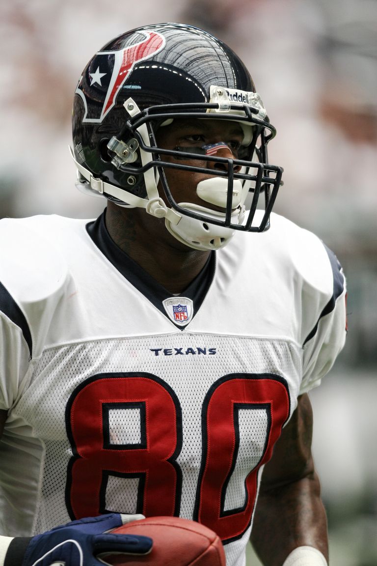 Close-up of an American football player during a game, showcasing determination.