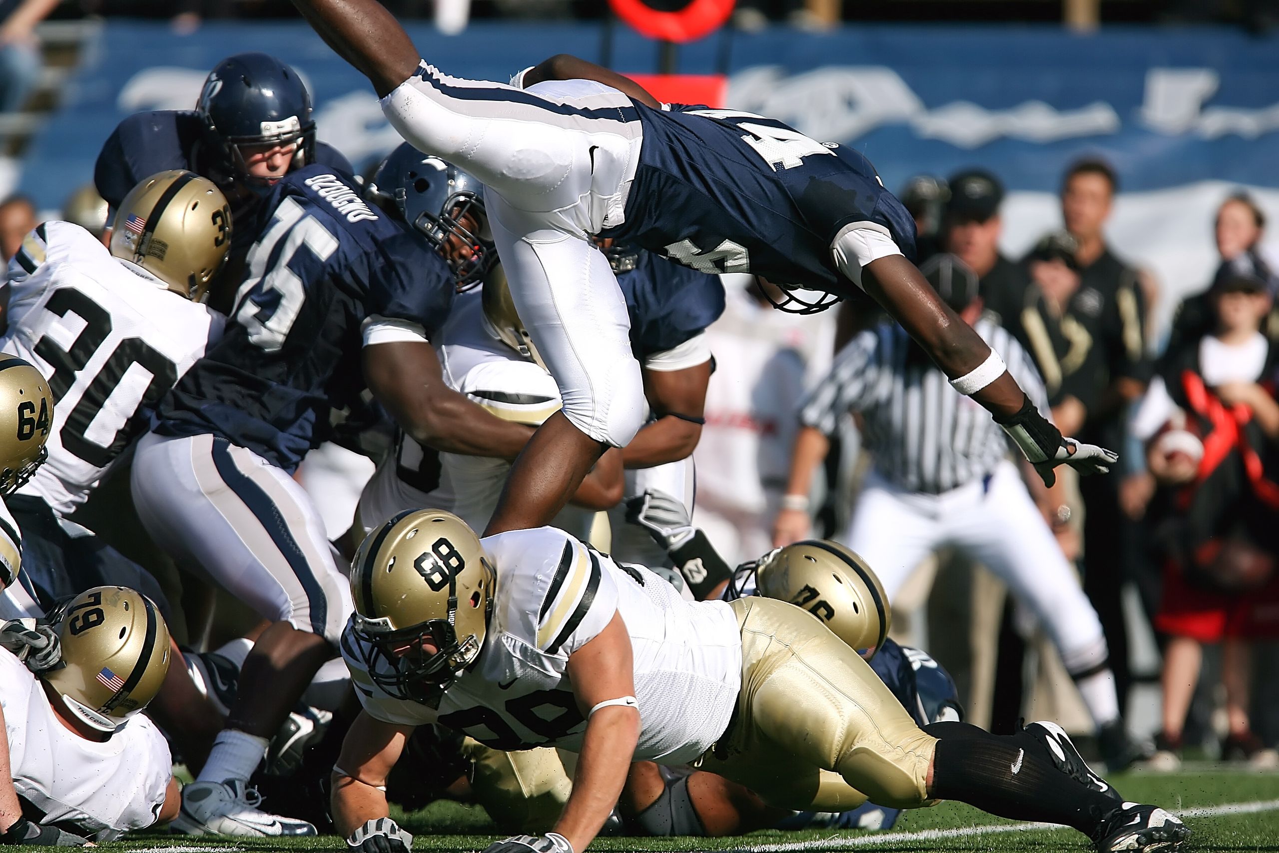 Dynamic action shot capturing athletes competing in an American football game.
