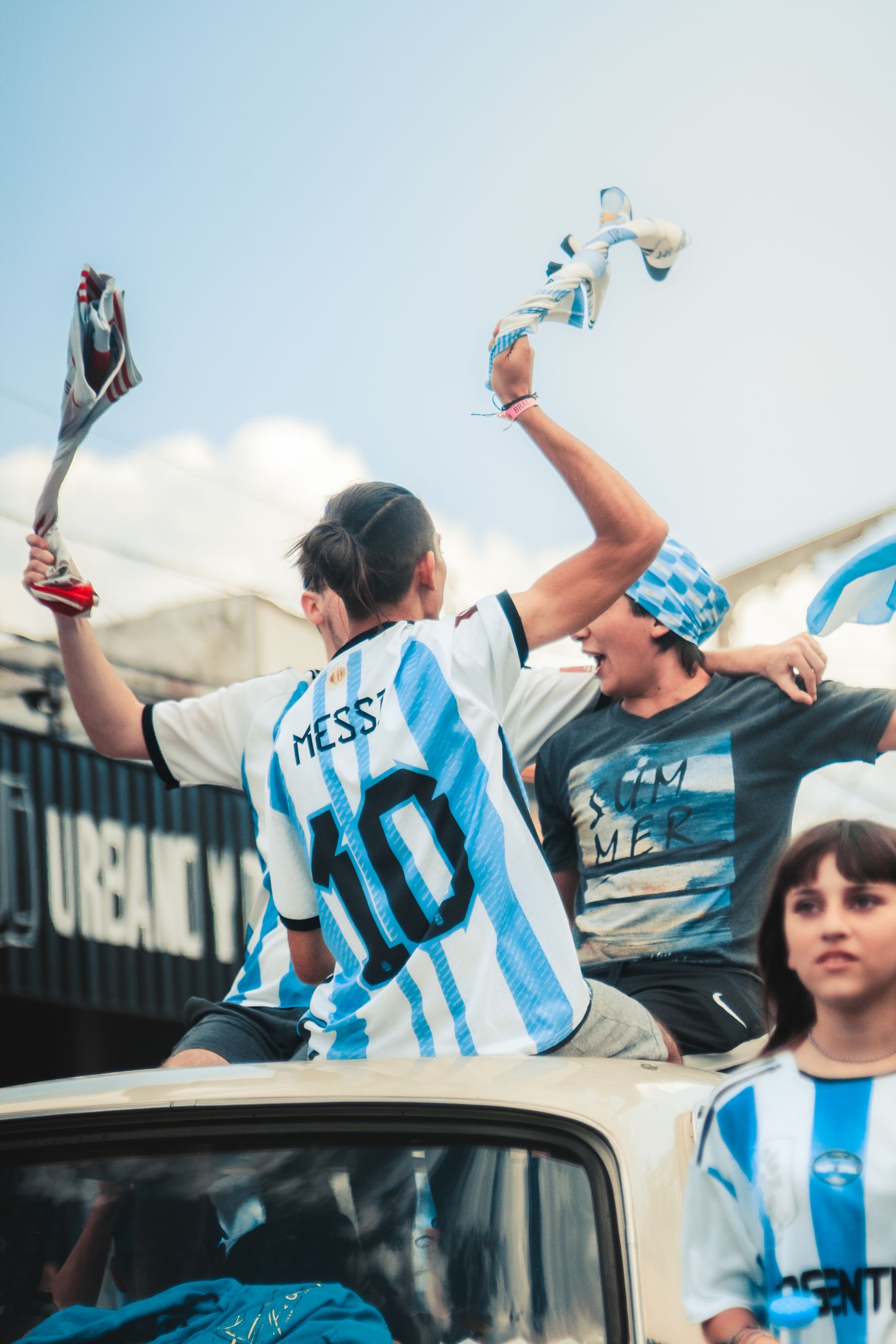 Fans celebrating a soccer victory with excitement and national pride.