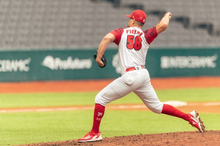 Baseball player pitching on a sunny day at a stadium, showcasing sportsmanship and athletic form.