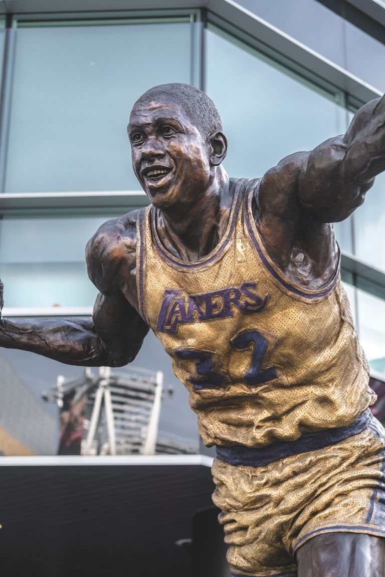 Bronze statue of famous basketball player in Lakers jersey outside Staples Center, Los Angeles.