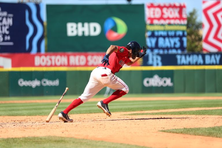 Dynamic shot of a baseball player sprinting on the field in Santo Domingo, Dominican Republic.