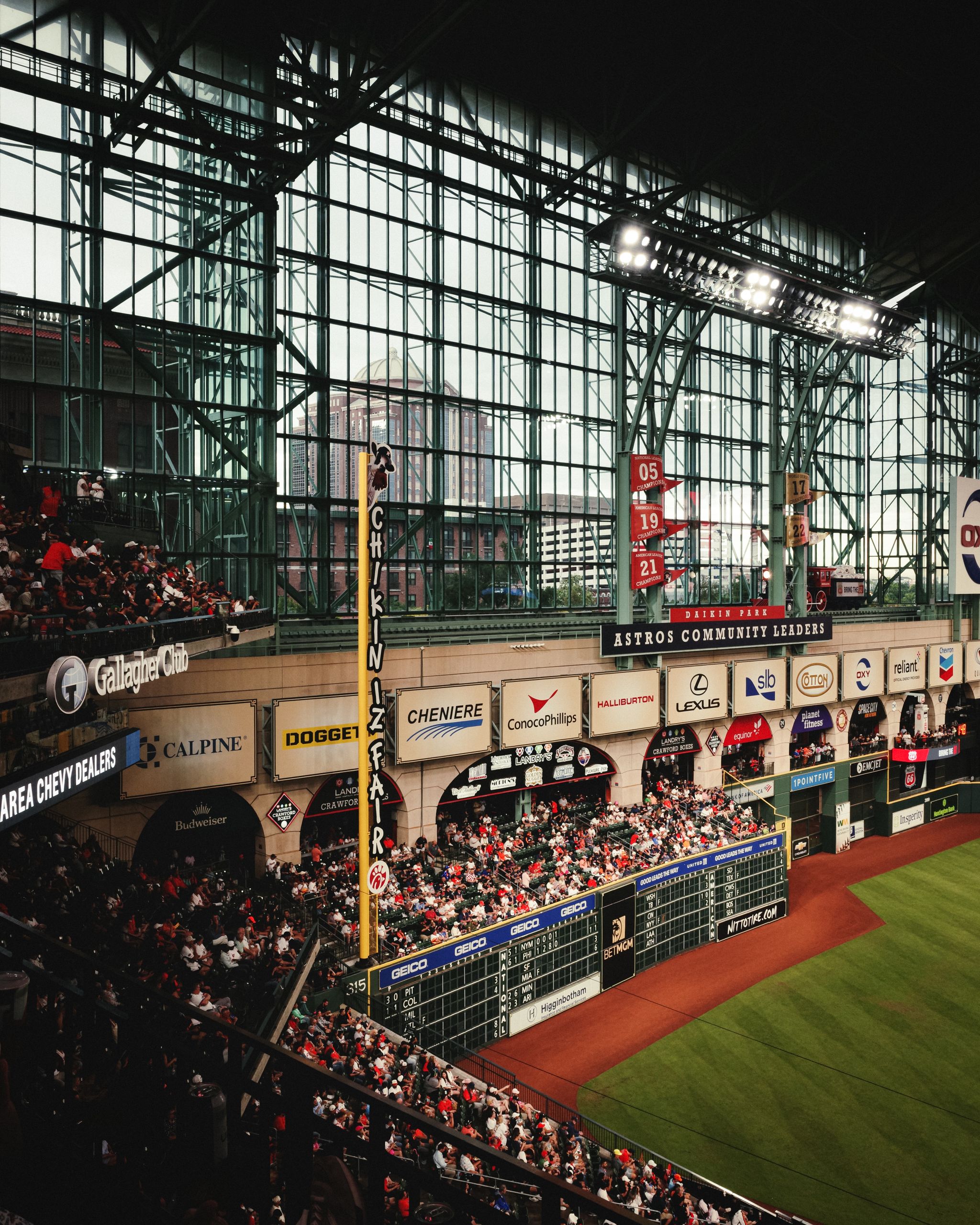 Wide view of Minute Maid Park, Houston, filled with baseball fans during a game.