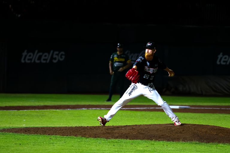 A baseball pitcher throws a pitch during a night game in San Francisco de Campeche, Mexico.