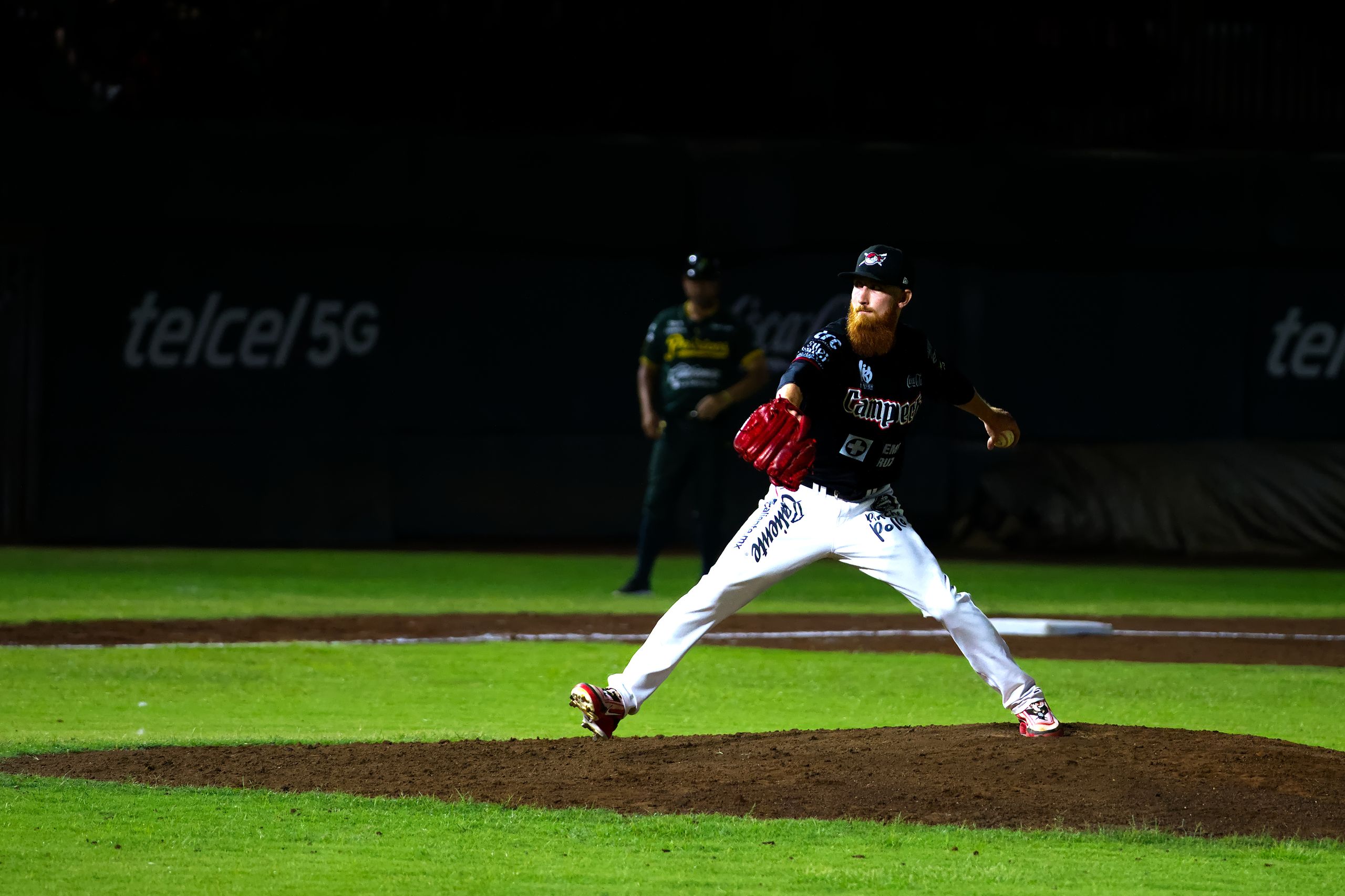 A baseball pitcher throws a pitch during a night game in San Francisco de Campeche, Mexico.