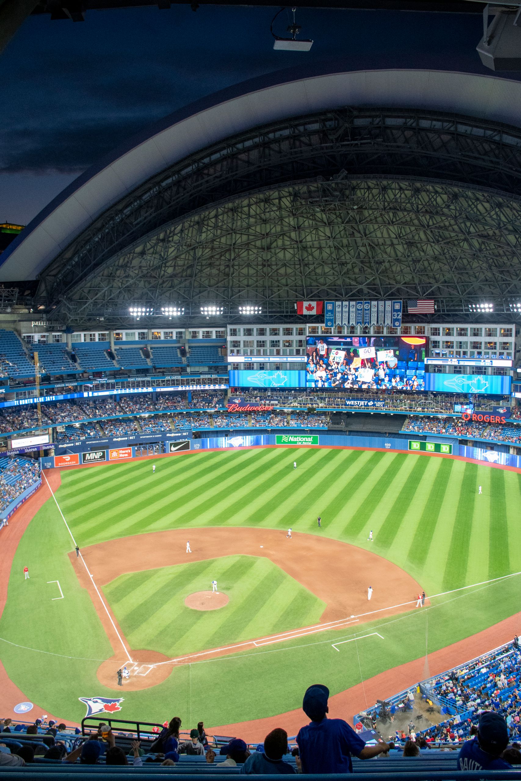 Enjoy a vibrant night at Rogers Centre with a baseball game in full swing under the dome.