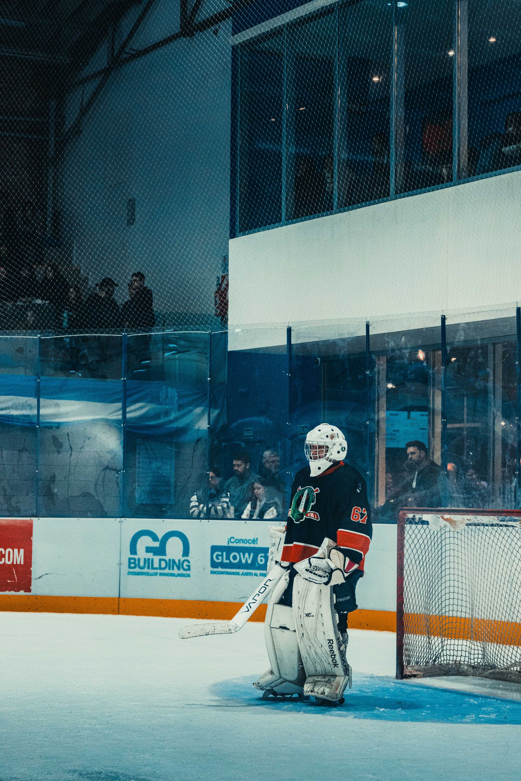 A focused ice hockey goalie standing guard in a Buenos Aires rink, ready for the shot.