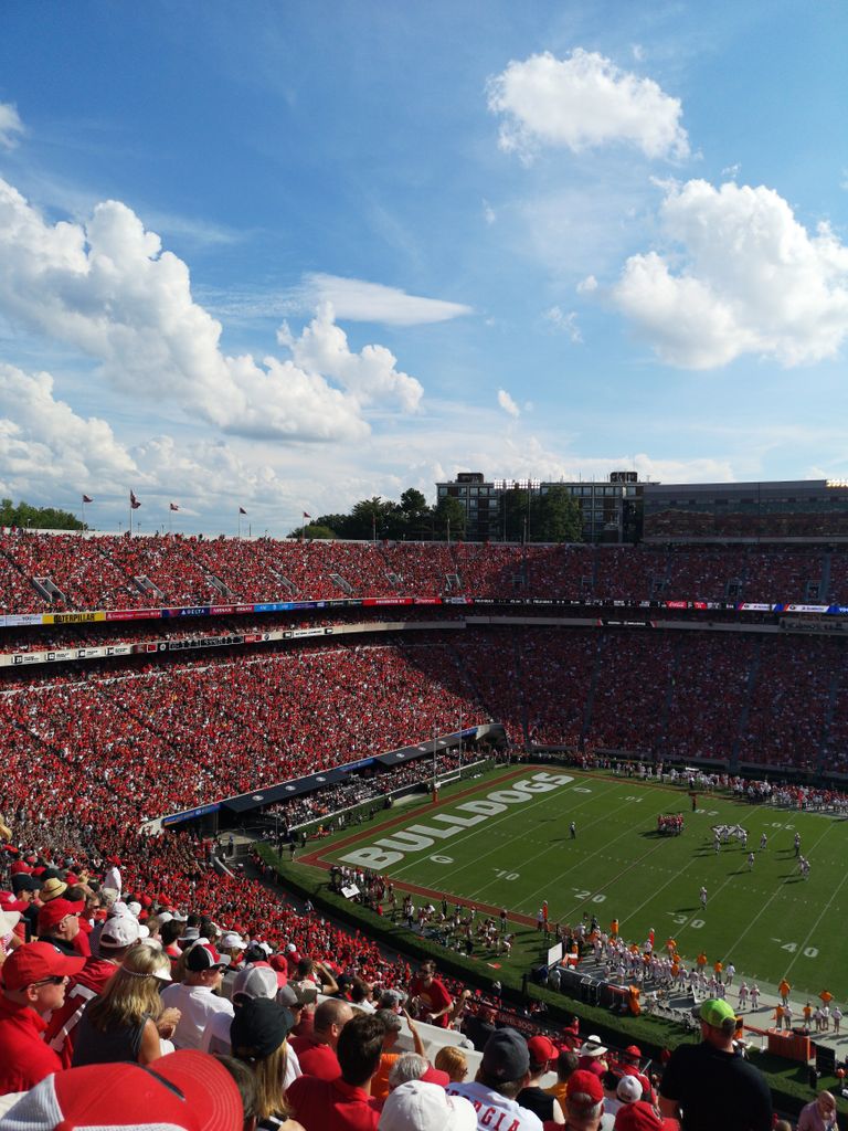 A vibrant college football game at a packed stadium in Athens, GA, USA. Great crowd atmosphere.