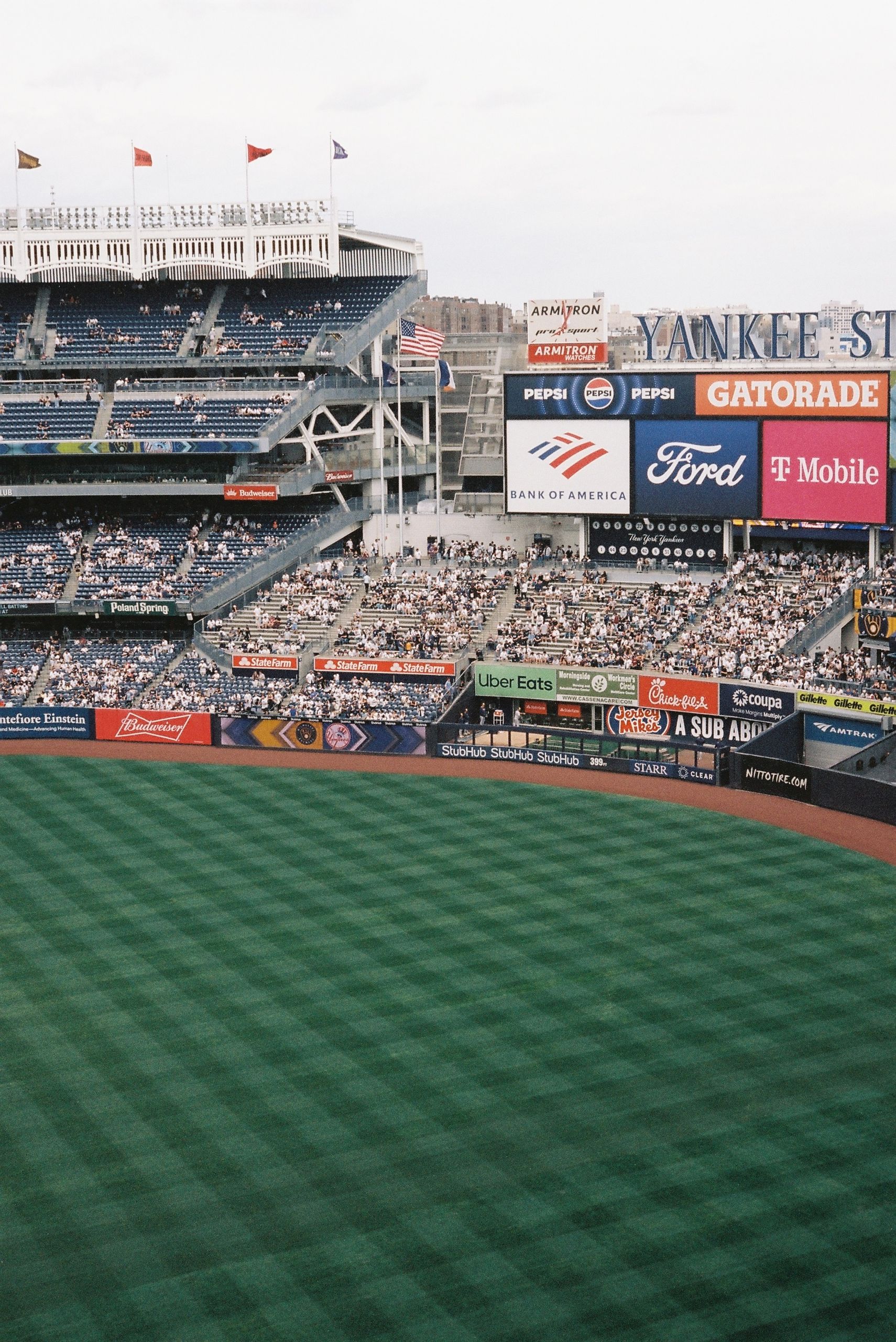 Aerial view of Yankee Stadium during a baseball game, showcasing vibrant green field and spectators.