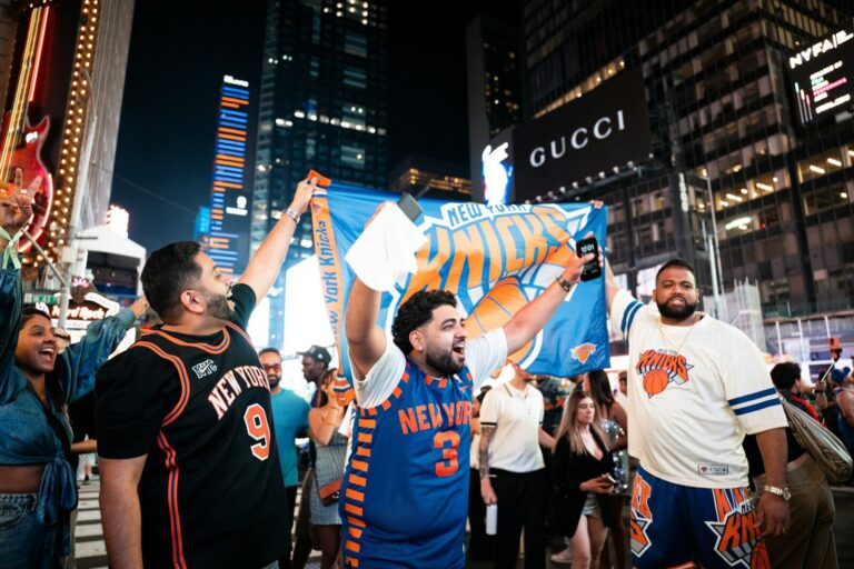 New york knicks fans celebrate in times square at night