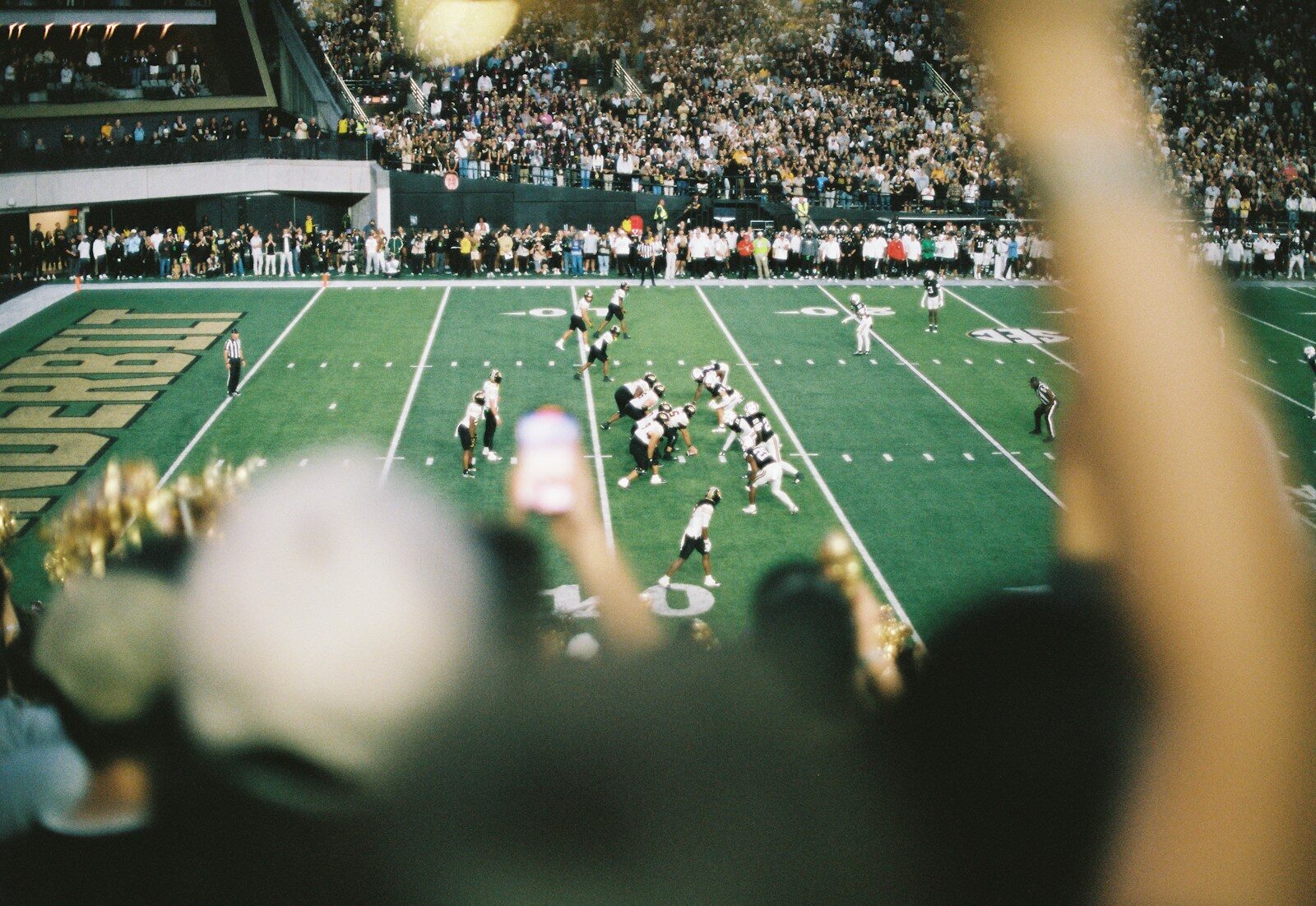 American football game played in a stadium with spectators