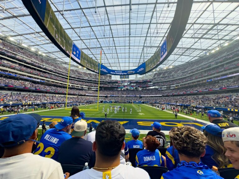 Spectators watch a football game in a modern stadium