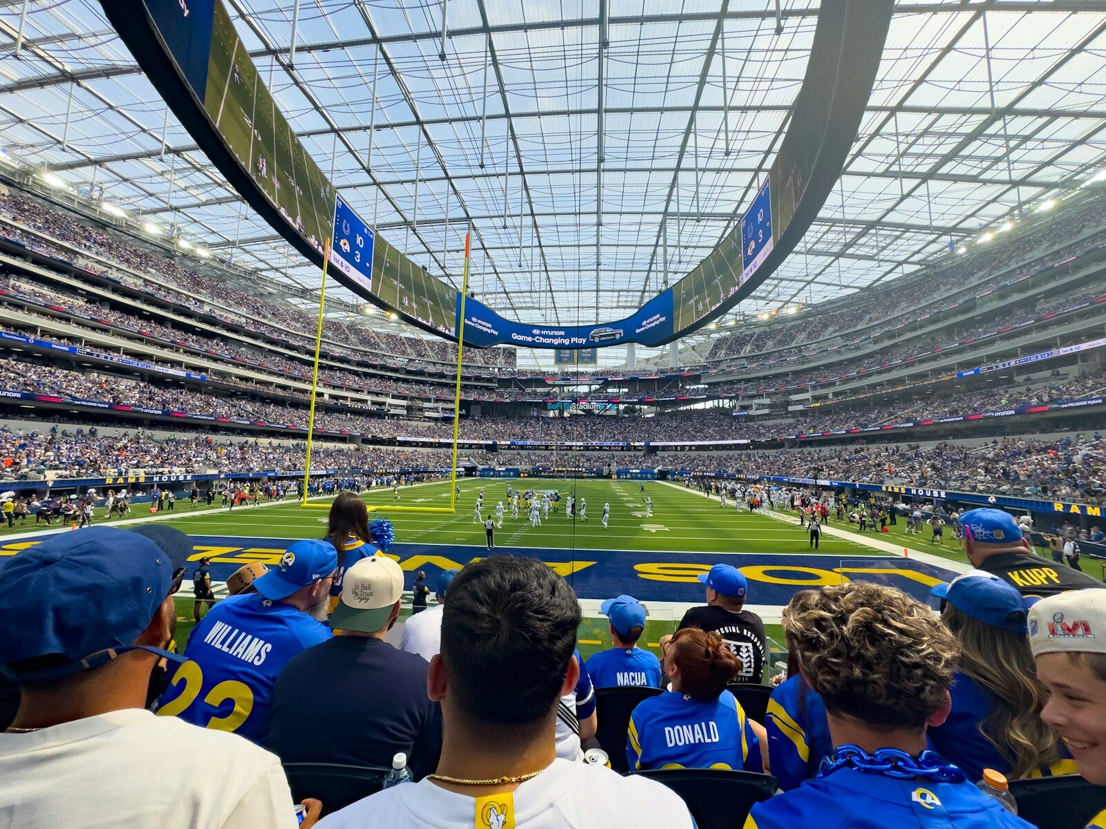 Spectators watch a football game in a modern stadium