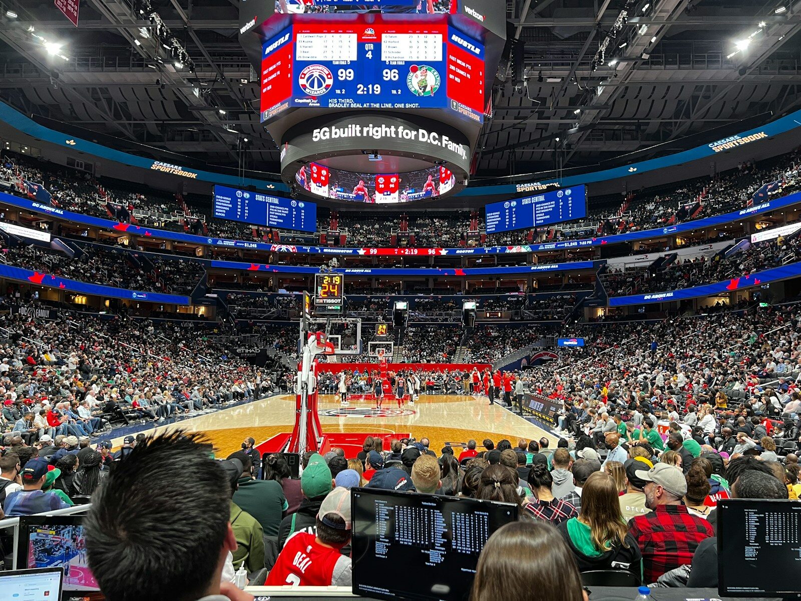 a crowd of people watching a basketball game