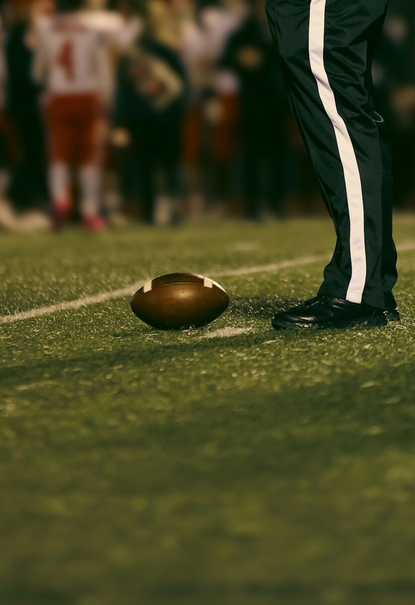 American football on field near person's feet